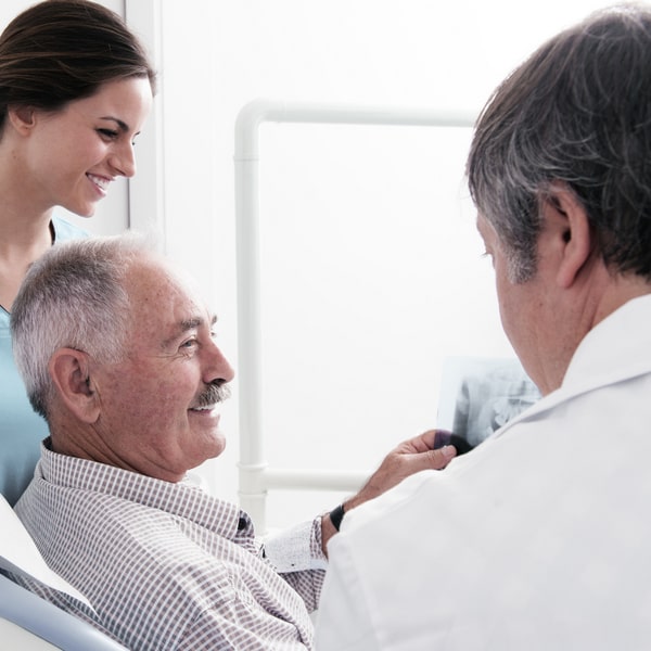 An elderly man at the dentist.