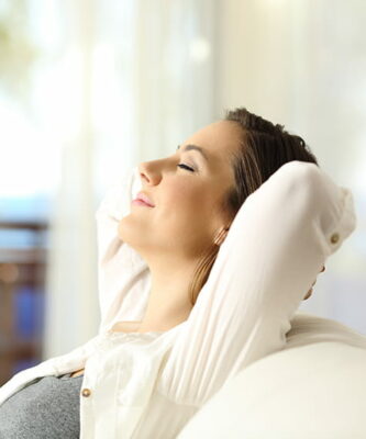 Woman relaxing after receiving TMJ treatment